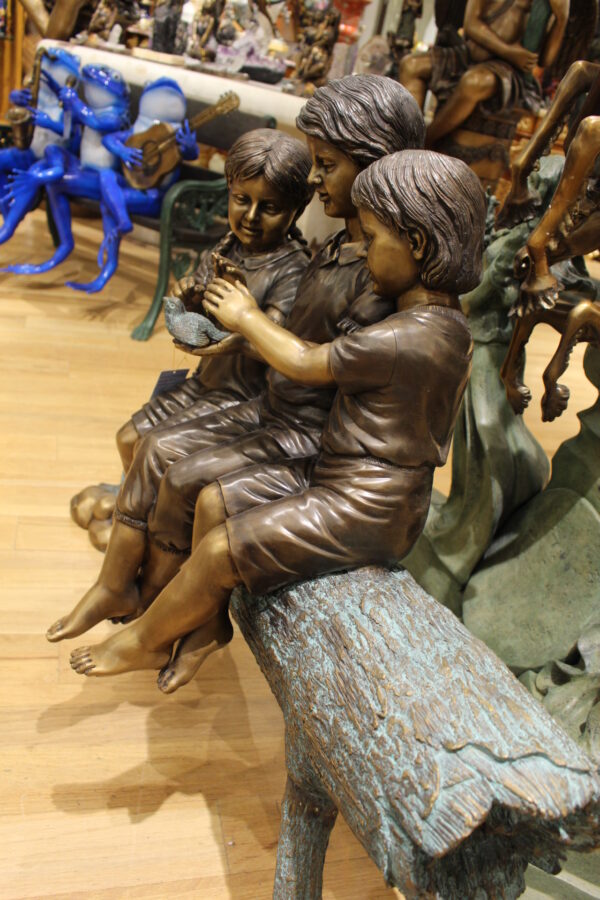 Three Children On Log Holding Bird Bronze Statue -  Size: 55"L x 18"W x 38"H.