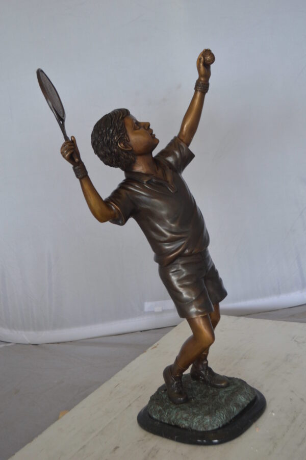 Boy Playing Tennis Bronze Statue -  Size: 12"L x 8"W x 25"H.