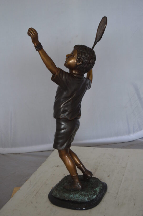 Boy Playing Tennis Bronze Statue -  Size: 12"L x 8"W x 25"H.