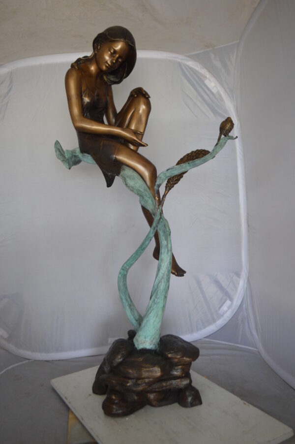 Beautiful Young Girl Sitting on a Tree Bronze Statue -  35"L x 50"W x 55"H.