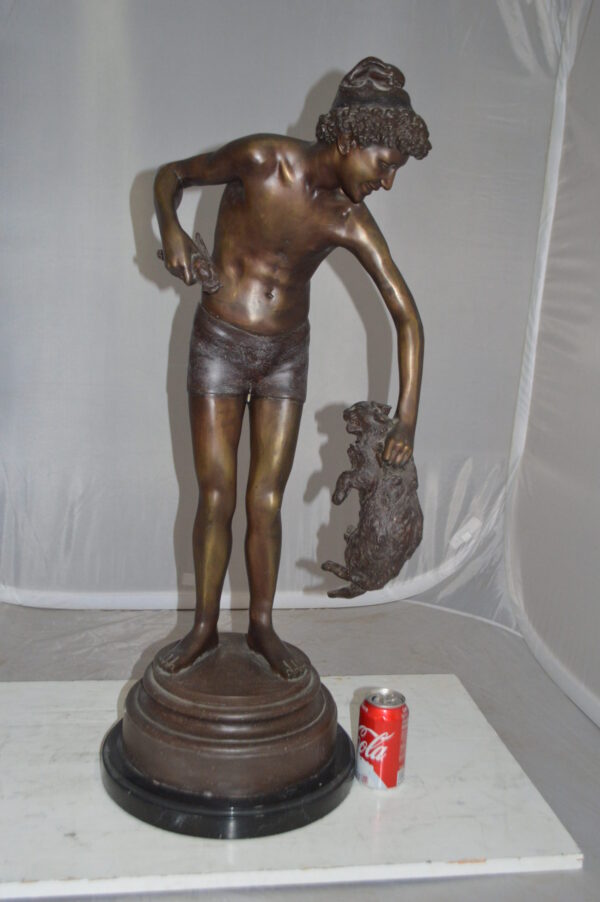 Boy holding a Dog and a Bird Bronze Statue -  Size: 15"L x 15"W x 36"H.