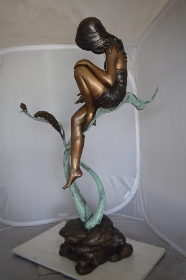 Beautiful Young Girl Sitting on a Tree Bronze Statue -  35"L x 50"W x 55"H.