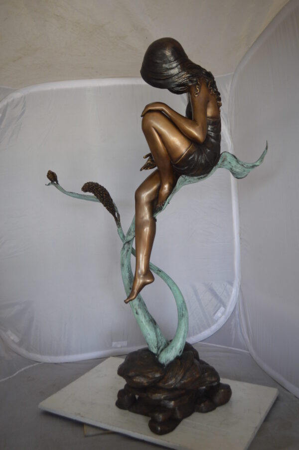 Beautiful Young Girl Sitting on a Tree Bronze Statue -  35"L x 50"W x 55"H.