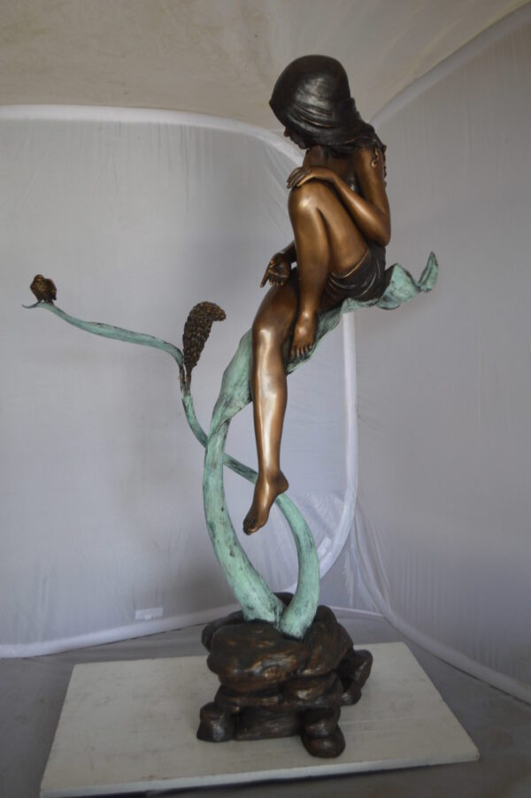 Beautiful Young Girl Sitting on a Tree Bronze Statue -  35"L x 50"W x 55"H.