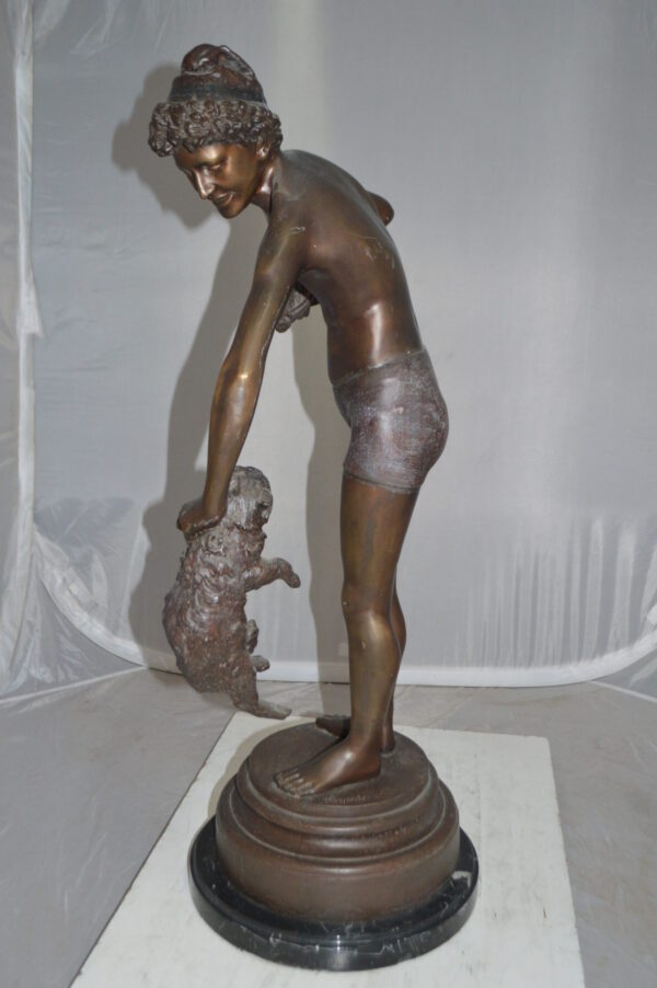 Boy holding a Dog and a Bird Bronze Statue -  Size: 15"L x 15"W x 36"H.
