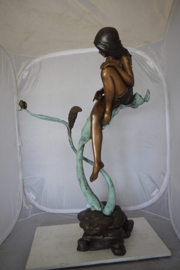 Beautiful Young Girl Sitting on a Tree Bronze Statue -  35"L x 50"W x 55"H.