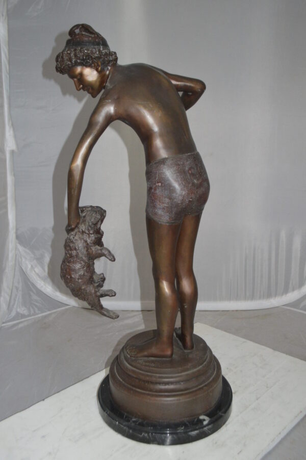 Boy holding a Dog and a Bird Bronze Statue -  Size: 15"L x 15"W x 36"H.