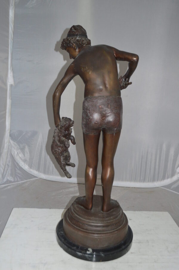 Boy holding a Dog and a Bird Bronze Statue -  Size: 15"L x 15"W x 36"H.