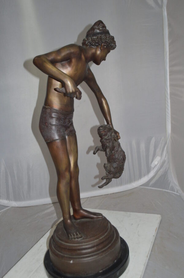 Boy holding a Dog and a Bird Bronze Statue -  Size: 15"L x 15"W x 36"H.