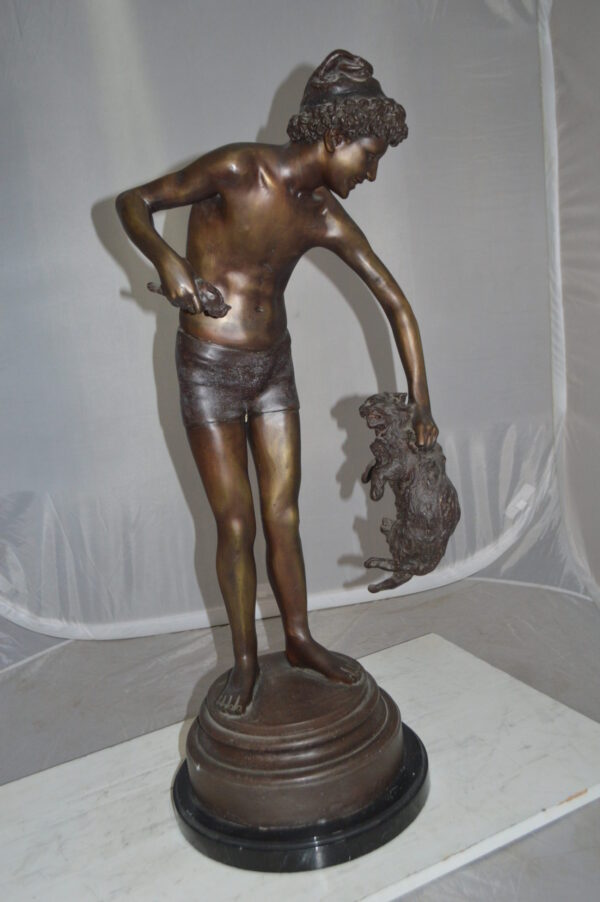 Boy holding a Dog and a Bird Bronze Statue -  Size: 15"L x 15"W x 36"H.