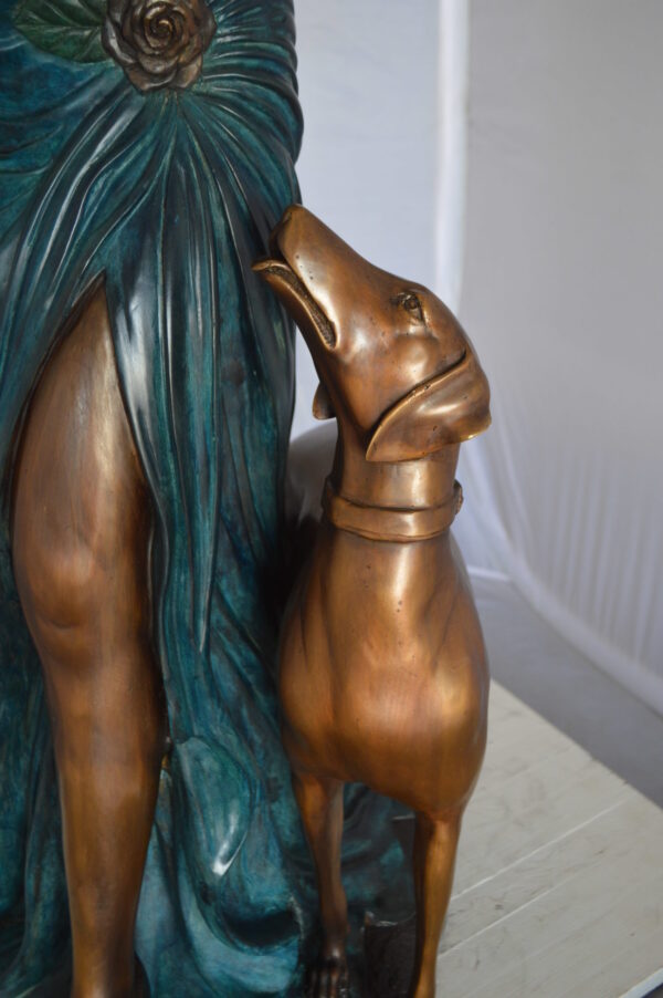 Lady With Her Dog Bronze Statue -  Size: 25"L x 22"W x 50"H.