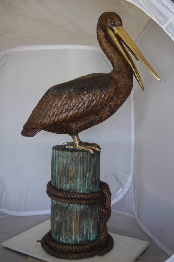 Pelican on a Stump Bronze Statue -  Size: 14"L x 38"W x 58"H.