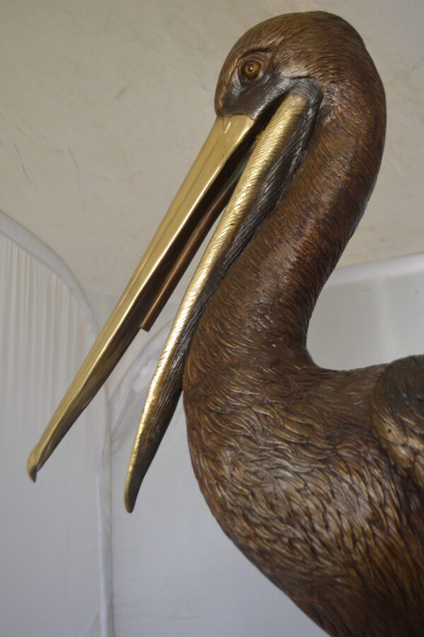 Pelican on a Stump Bronze Statue -  Size: 14"L x 38"W x 58"H.