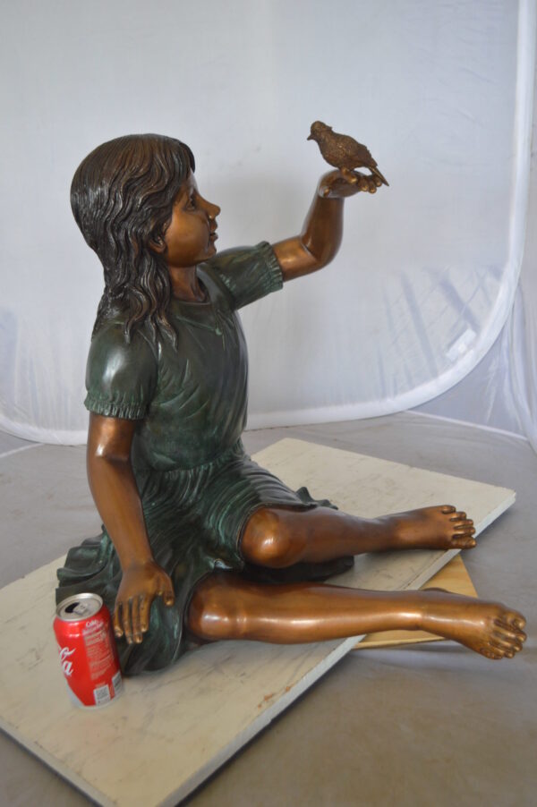 Girl with a Sparrow Bronze Statue -  Size: 24"L x 30"W x 25"H.