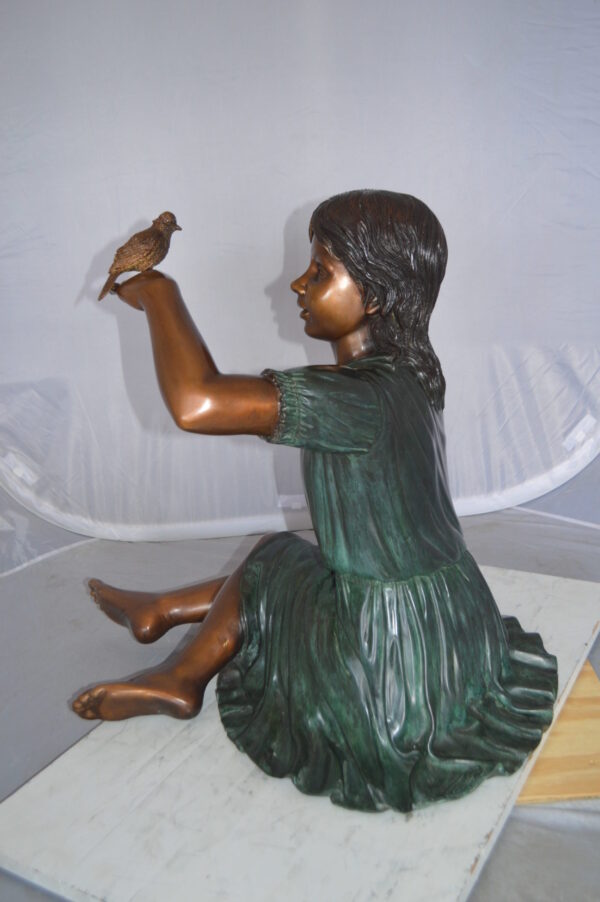 Girl with a Sparrow Bronze Statue -  Size: 24"L x 30"W x 25"H.