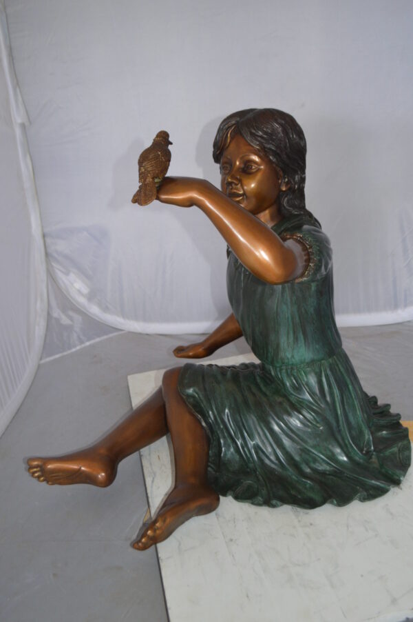 Girl with a Sparrow Bronze Statue -  Size: 24"L x 30"W x 25"H.