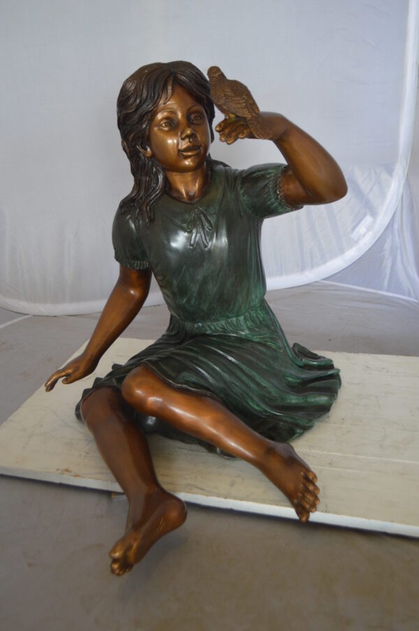 Girl with a Sparrow Bronze Statue -  Size: 24"L x 30"W x 25"H.