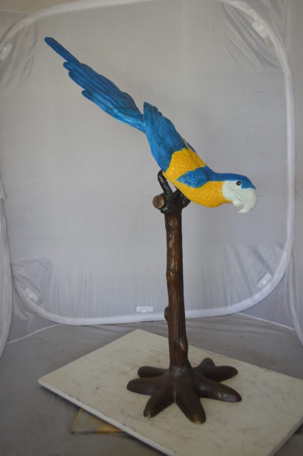 Parrot on Tree - Head Down Bronze Statue -  Size: 39"L x 15"W x 47"H.