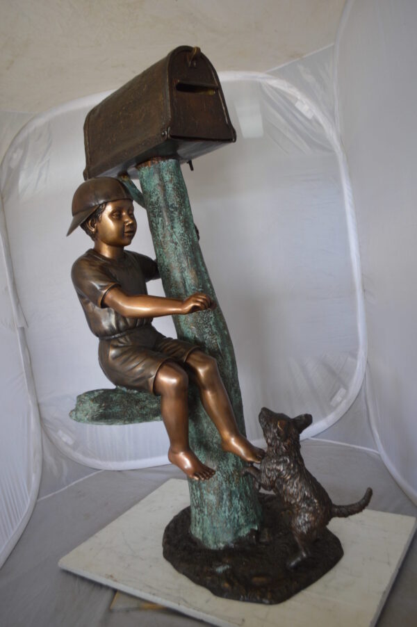 Boy Sitting on a Tree with Mailbox Bronze Statue -  Size: 22"L x 23"W x 49"H.