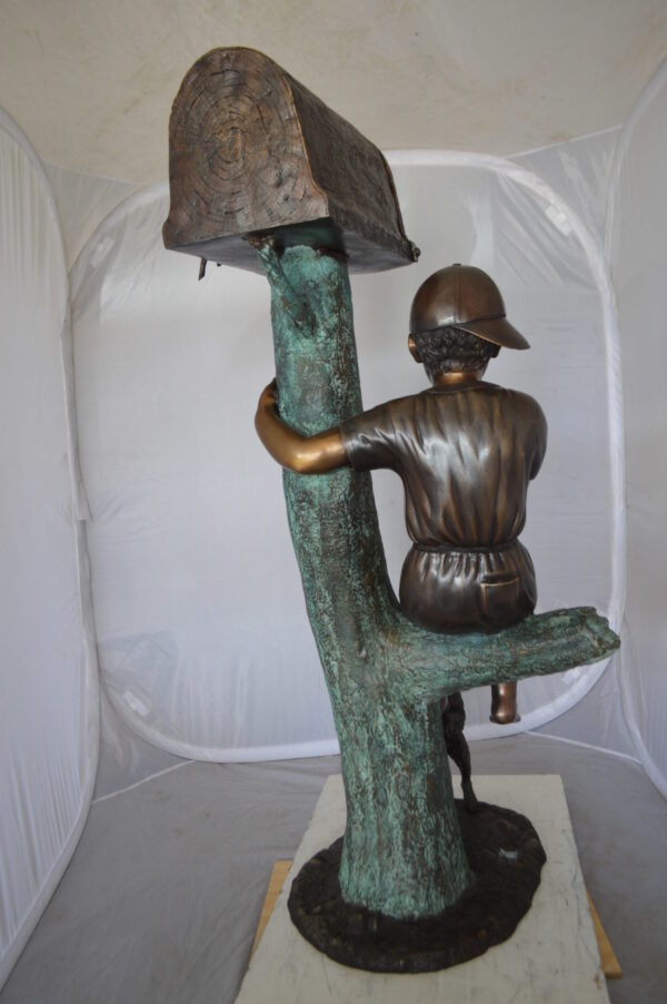 Boy Sitting on a Tree with Mailbox Bronze Statue -  Size: 22"L x 23"W x 49"H.