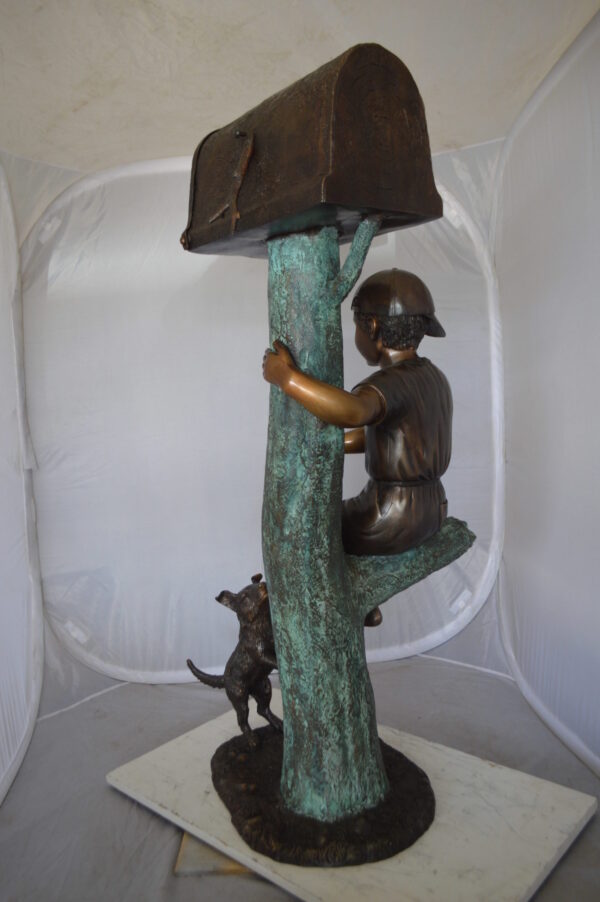 Boy Sitting on a Tree with Mailbox Bronze Statue -  Size: 22"L x 23"W x 49"H.