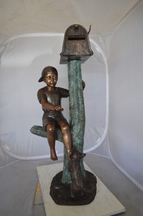 Boy Sitting on a Tree with Mailbox Bronze Statue -  Size: 22"L x 23"W x 49"H.