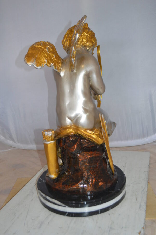 Cupid Boy On A Rock Bronze Statue  -  Size: 20"L x 15"W x 26"H.