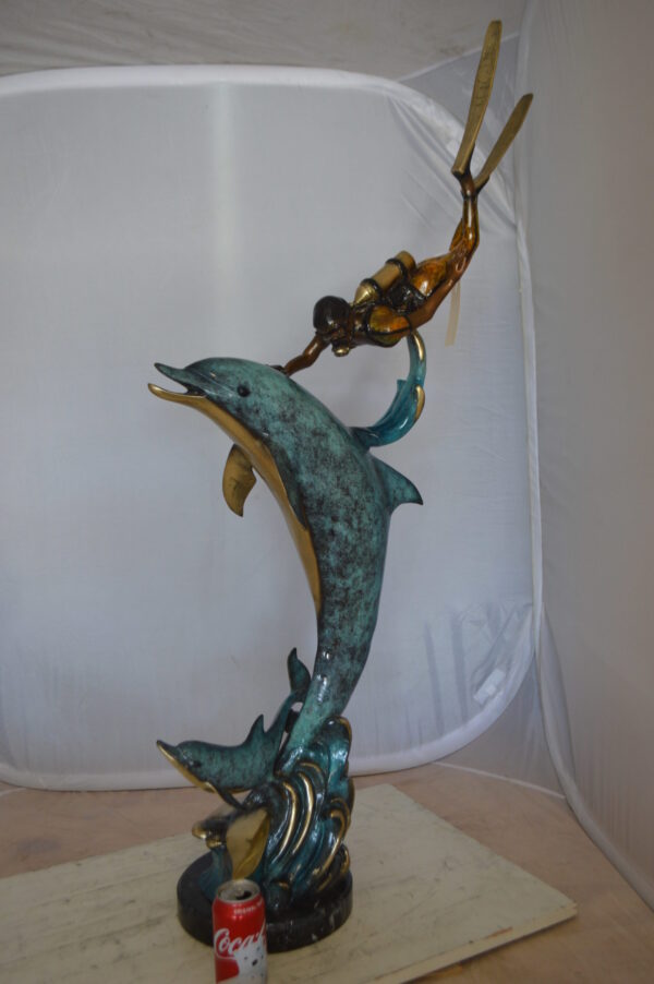 Diver With Dolphin Bronze Statue -  Size: 10"L x 30"W x 49"H.