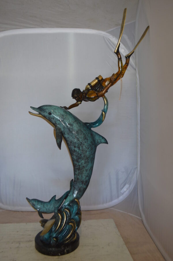 Diver With Dolphin Bronze Statue -  Size: 10"L x 30"W x 49"H.