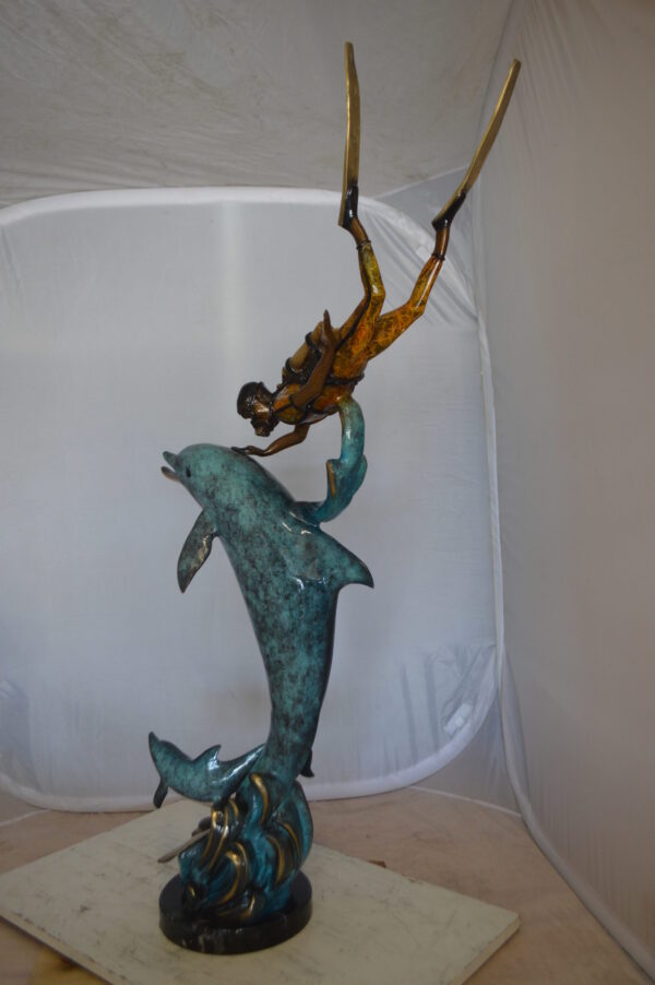 Diver With Dolphin Bronze Statue -  Size: 10"L x 30"W x 49"H.