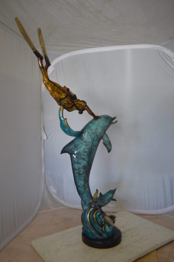 Diver With Dolphin Bronze Statue -  Size: 10"L x 30"W x 49"H.