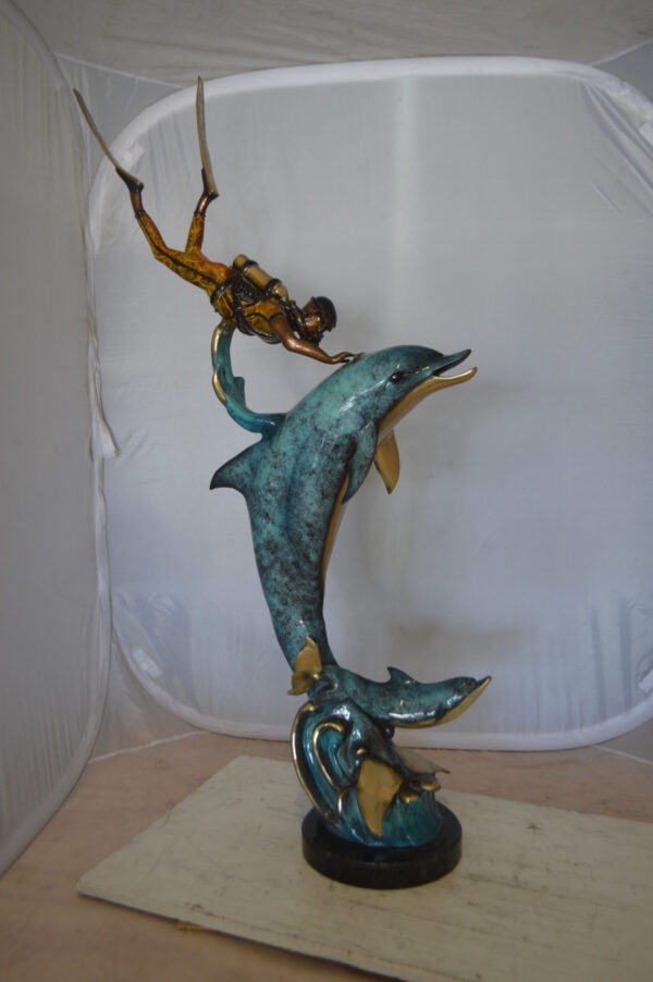 Diver With Dolphin Bronze Statue -  Size: 10"L x 30"W x 49"H.