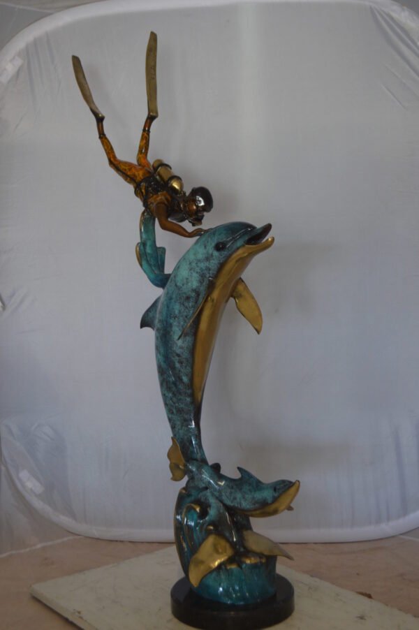 Diver With Dolphin Bronze Statue -  Size: 10"L x 30"W x 49"H.