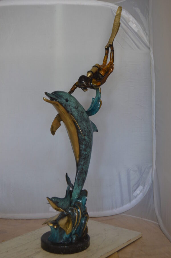 Diver With Dolphin Bronze Statue -  Size: 10"L x 30"W x 49"H.