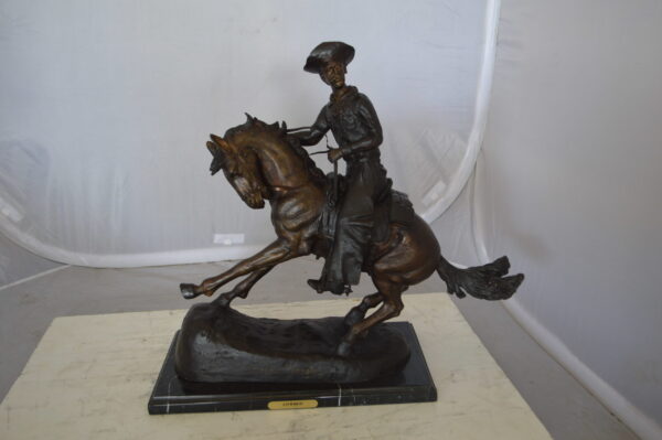 Remington Cowboy on marble Bronze Statue -  Size: 24"L x 9"W x 23"H.