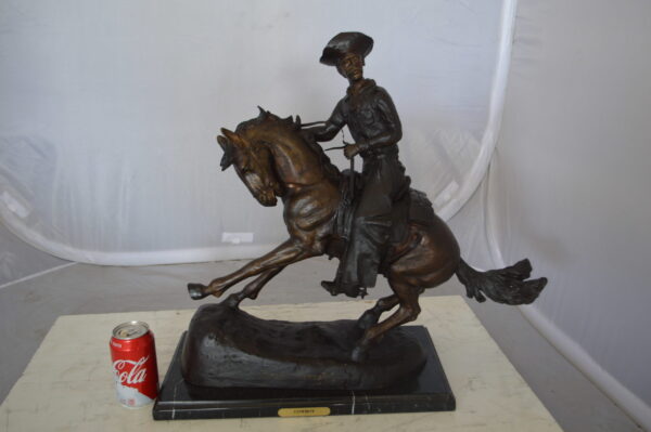 Remington Cowboy on marble Bronze Statue -  Size: 24"L x 9"W x 23"H.