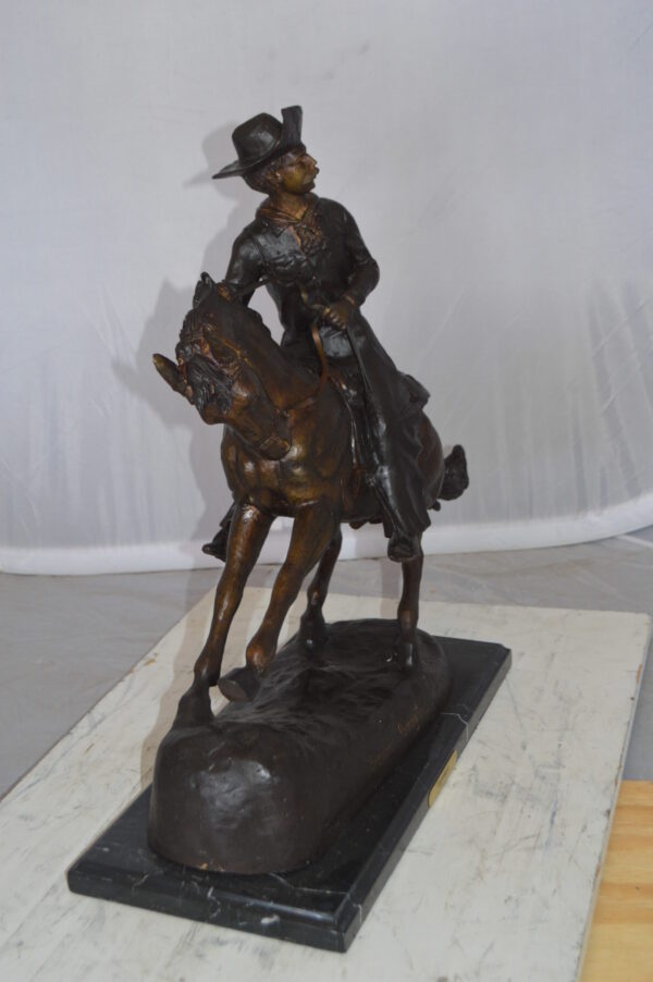 Remington Cowboy on marble Bronze Statue -  Size: 24"L x 9"W x 23"H.