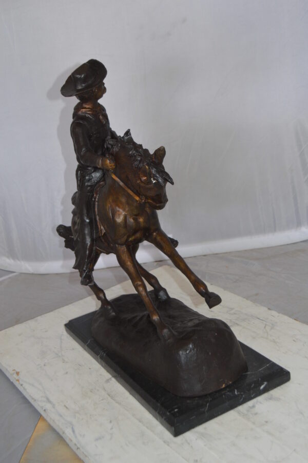 Remington Cowboy on marble Bronze Statue -  Size: 24"L x 9"W x 23"H.