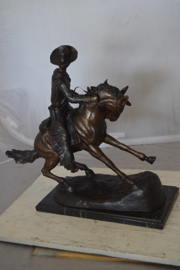 Remington Cowboy on marble Bronze Statue -  Size: 24"L x 9"W x 23"H.