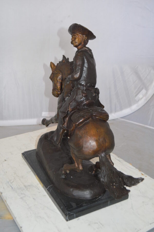 Remington Cowboy on marble Bronze Statue -  Size: 24"L x 9"W x 23"H.