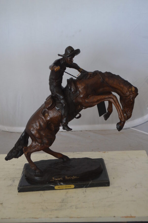 Bronco Buster Bronze Statue by Remington -  Size: 9"L x 24"W x 21"H.