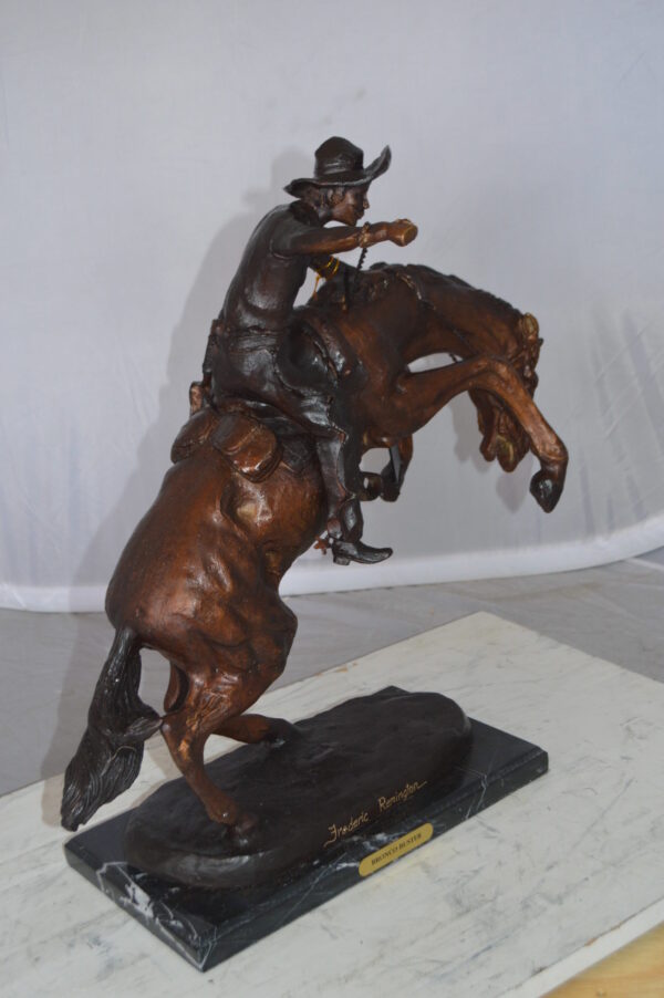 Bronco Buster Bronze Statue by Remington -  Size: 9"L x 24"W x 21"H.