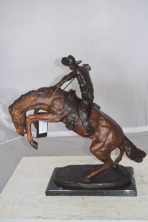 Bronco Buster Bronze Statue by Remington -  Size: 9"L x 24"W x 21"H.