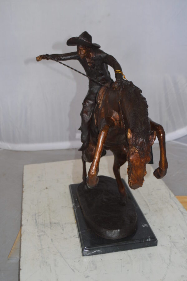 Bronco Buster Bronze Statue by Remington -  Size: 9"L x 24"W x 21"H.