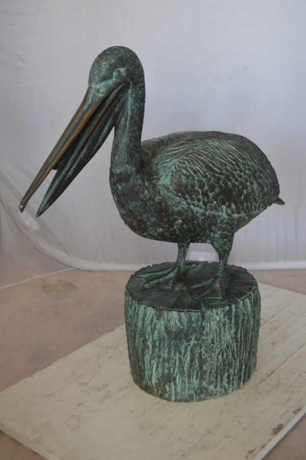 Pelican on a Tree Stump fountain bronze statue -  Size: 30"L x 16"W x 46"H.