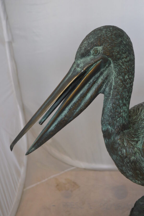 Pelican on a Tree Stump fountain bronze statue -  Size: 30"L x 16"W x 46"H.