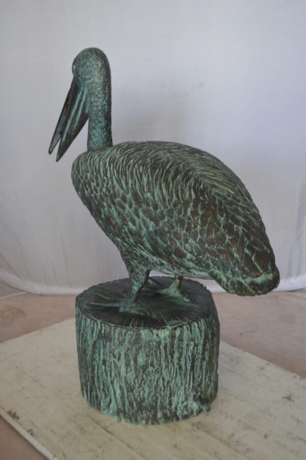 Pelican on a Tree Stump fountain bronze statue -  Size: 30"L x 16"W x 46"H.