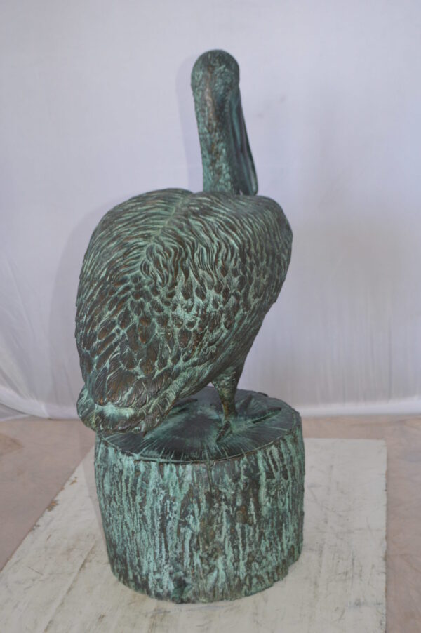 Pelican on a Tree Stump fountain bronze statue -  Size: 30"L x 16"W x 46"H.