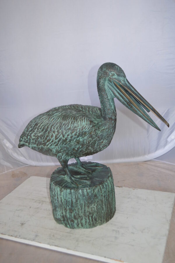 Pelican on a Tree Stump fountain bronze statue -  Size: 30"L x 16"W x 46"H.