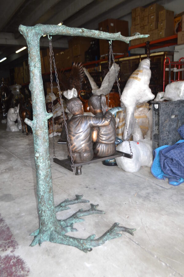 Kids on Swing Set Reading a Book Life Size Bronze Statue -  50"L x 40"W x 70"H.